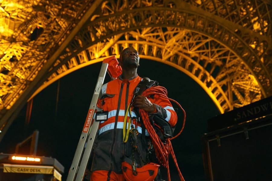 Under the Eiffel Tower at night in Part 4